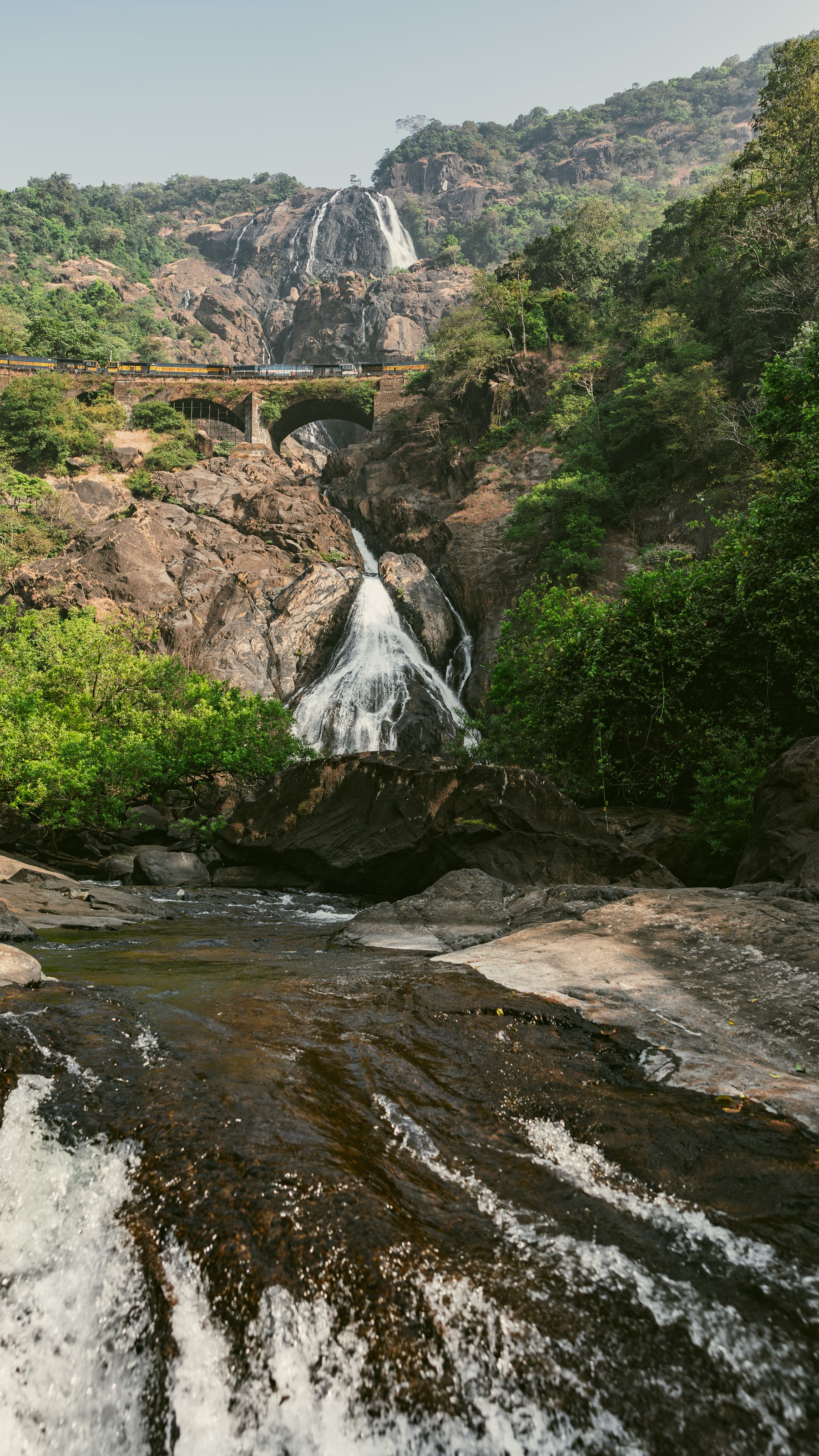 Multi-Tier Forest Waterfall And Rocky Stream